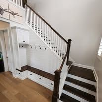 There is a staircase with a bench underneath it.