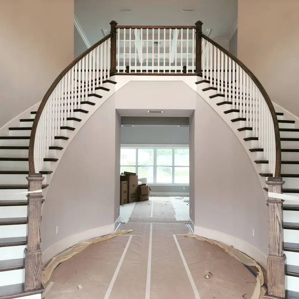A curved staircase leading up to the second floor of a house