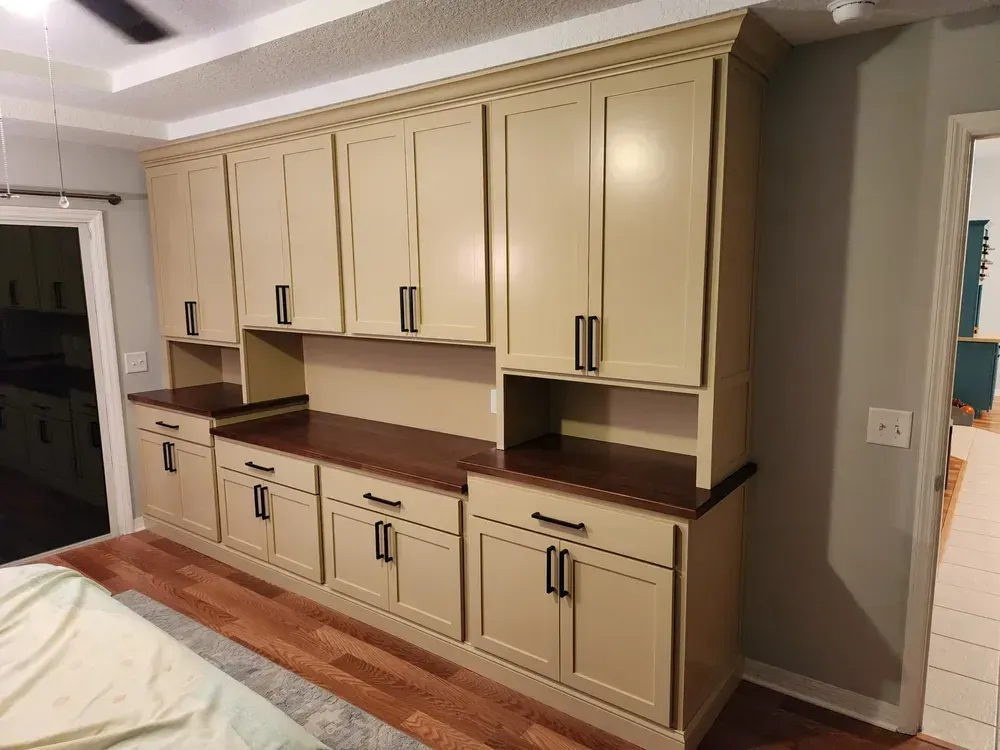 A kitchen with a lot of cabinets and a ceiling fan.