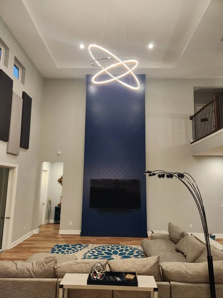 A living room with a couch and a tv on the wall