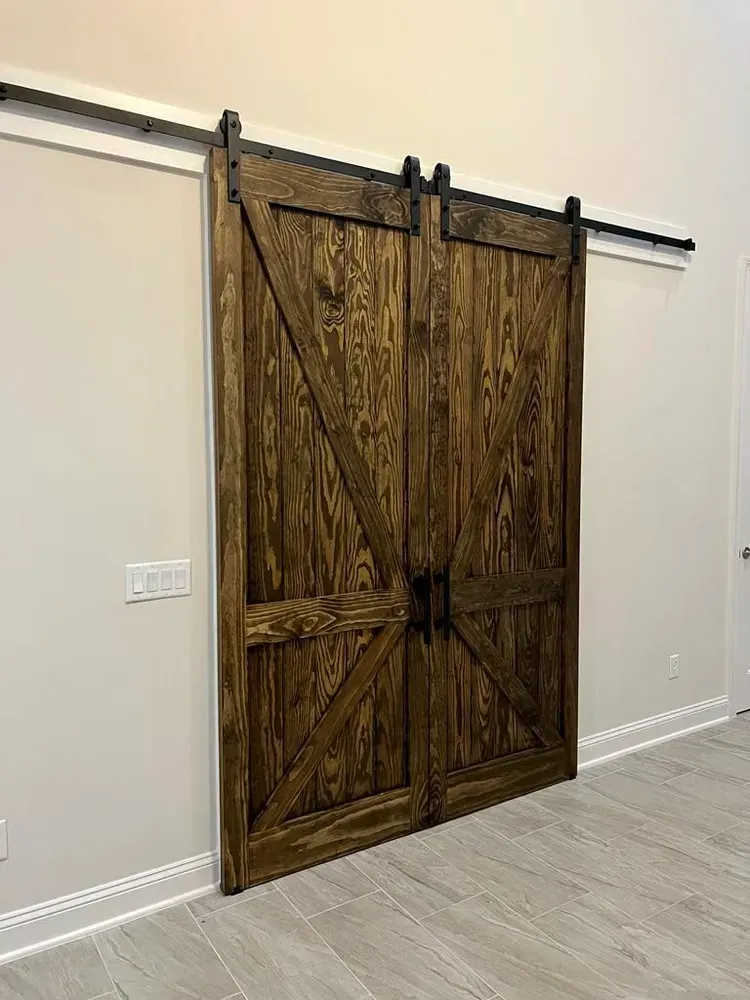 A pair of wooden sliding barn doors in a room.