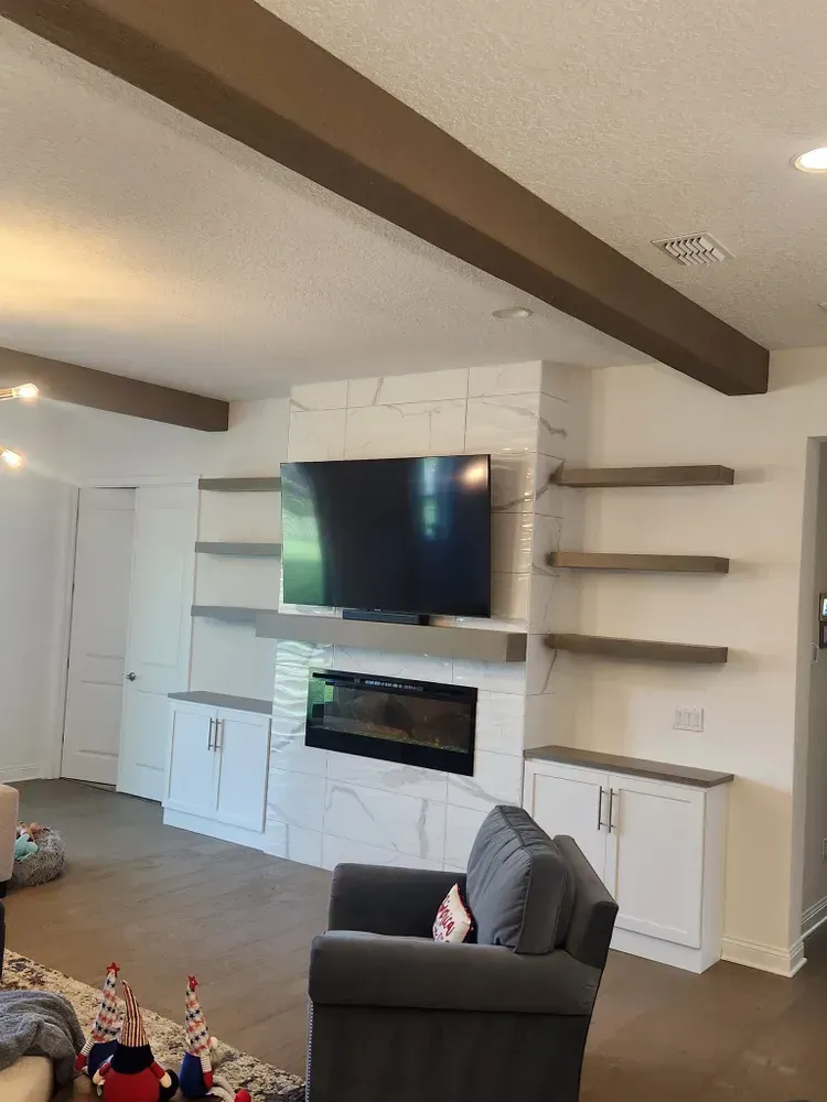 A living room with a fireplace and a flat screen tv