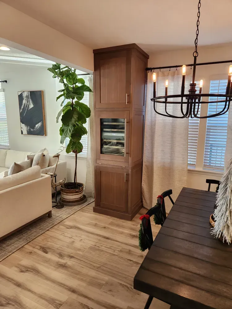 A living room with a couch , table , chairs and a chandelier.