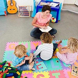 Teacher reading to students - academy program in Amrion, IA