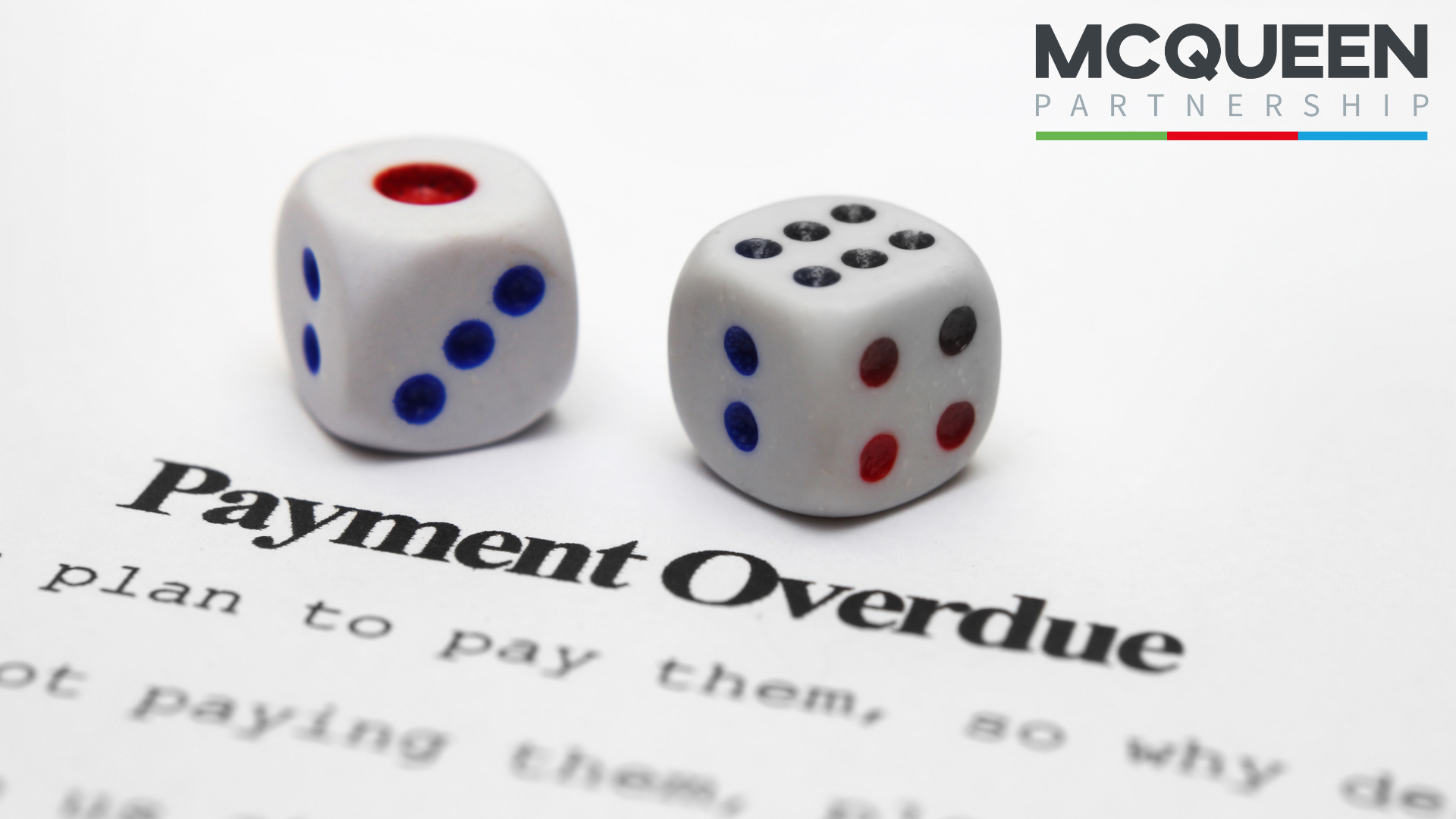 Two dice on top of a paper that says payment overdue