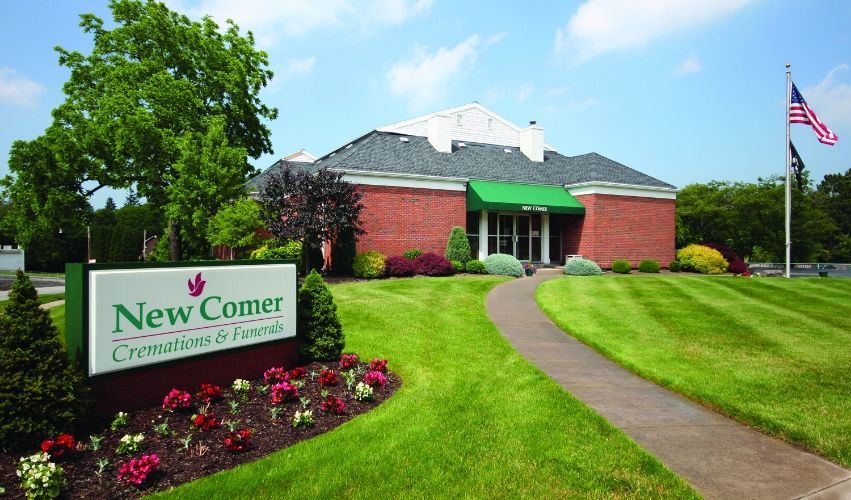 A brick building with a sign that says new corner