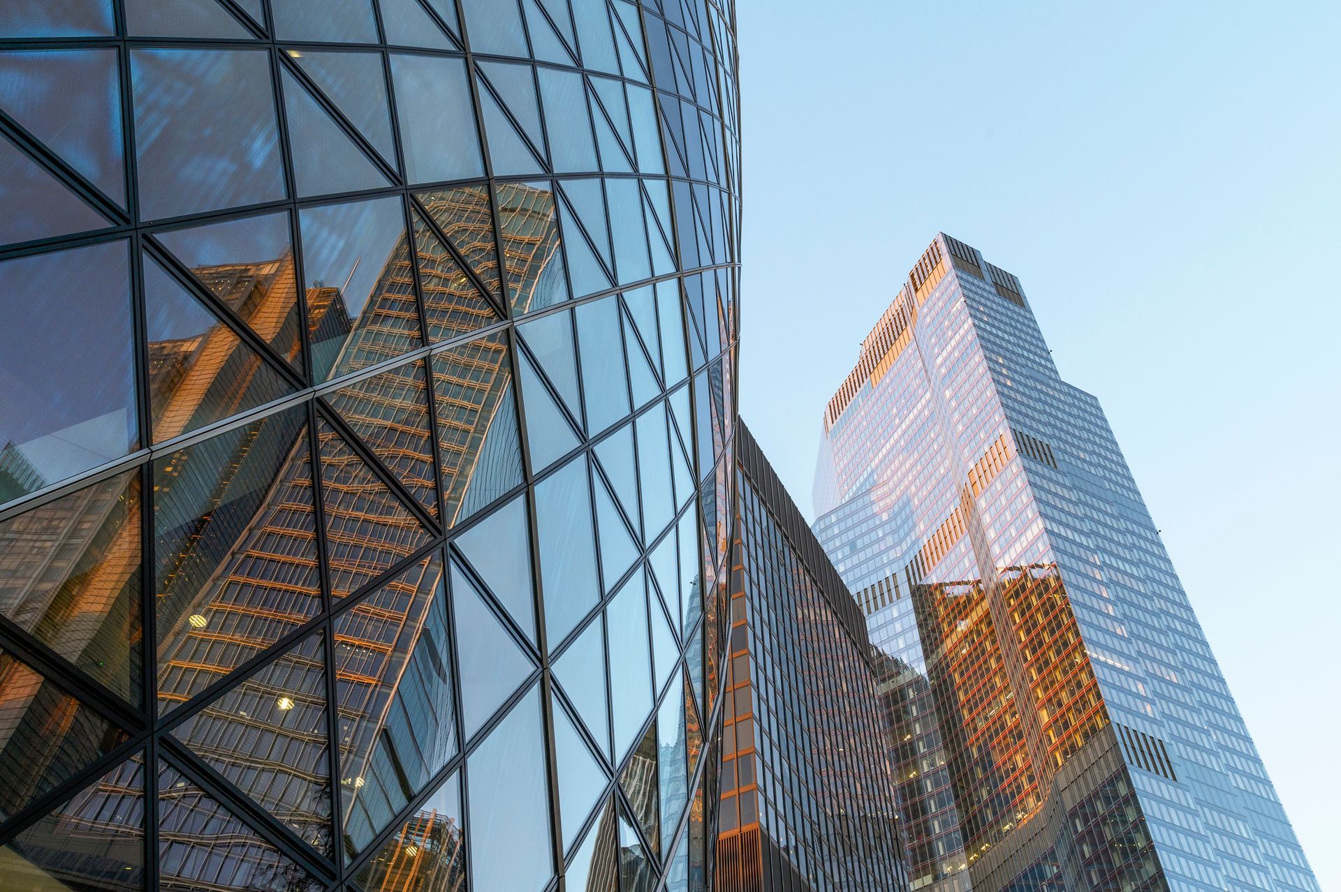 A woman is sitting at a table writing on a clipboard.