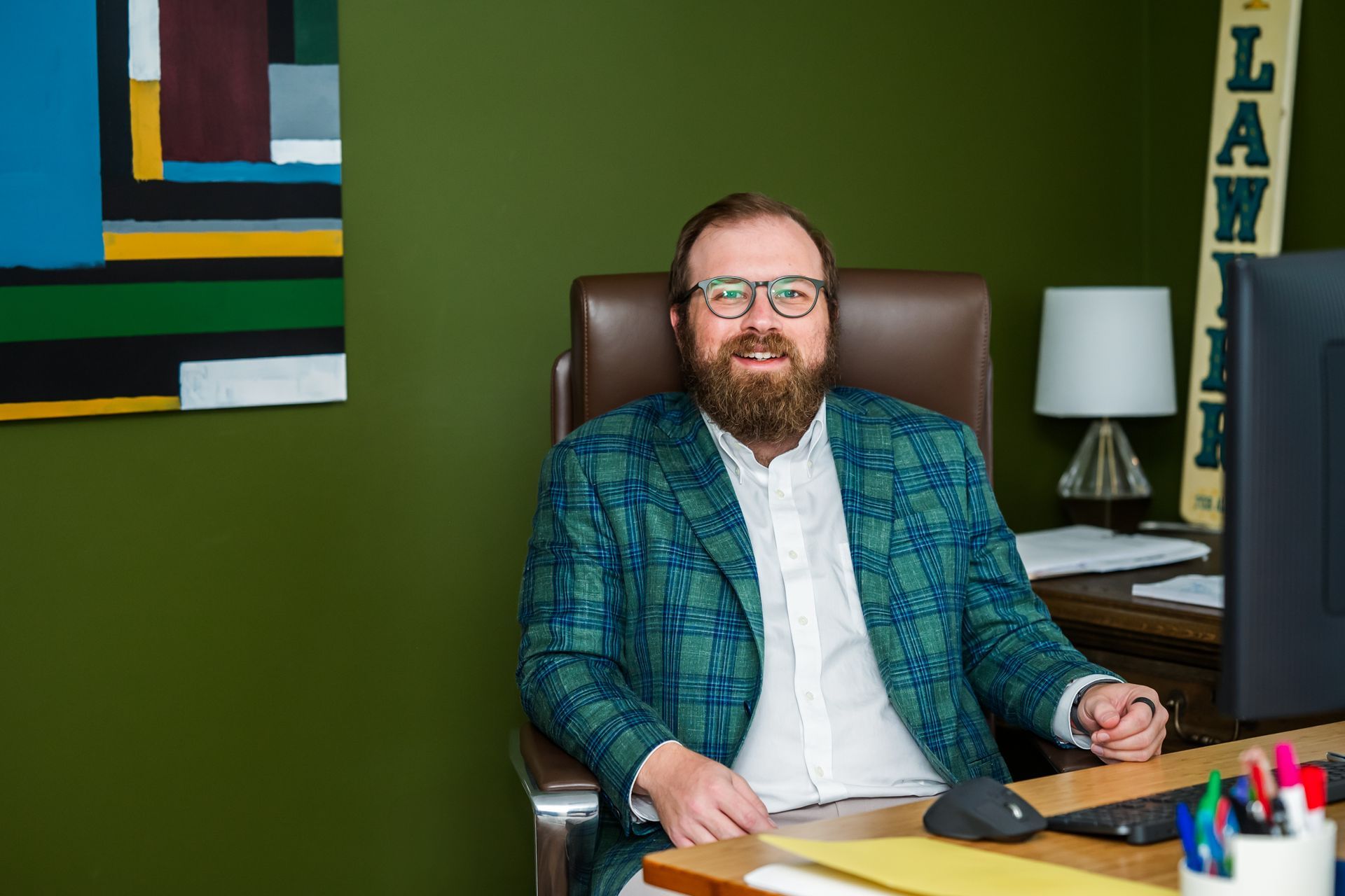 A woman is sitting at a table writing on a clipboard.