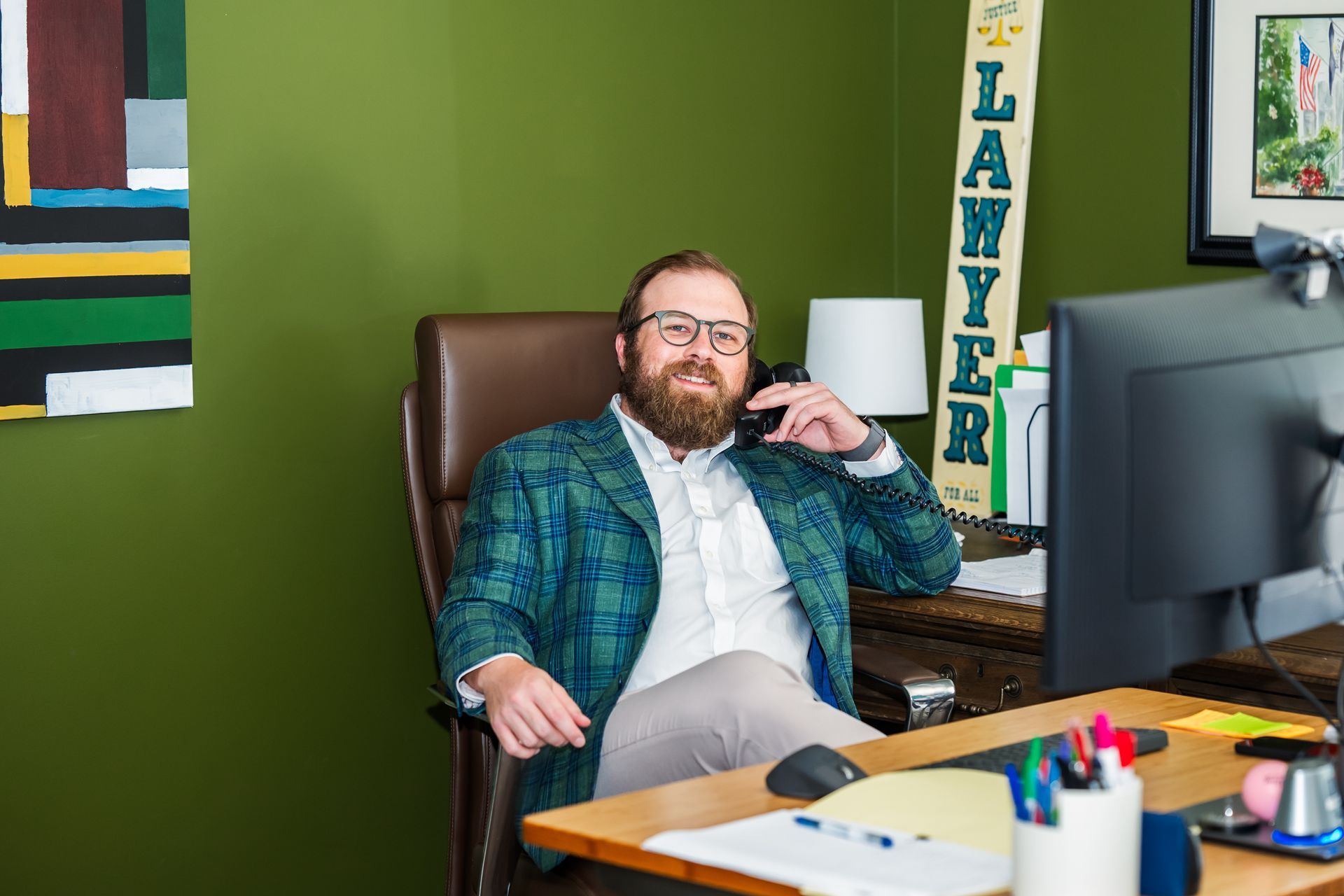 A woman is sitting at a table writing on a clipboard.