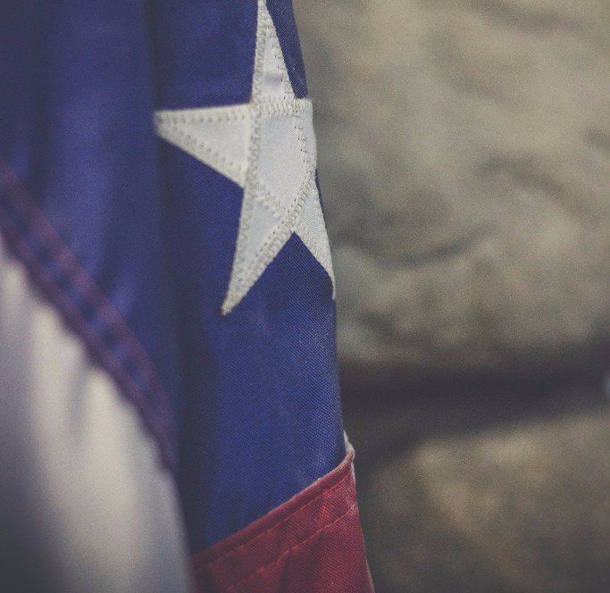 A close up of an american flag with a white star on it.