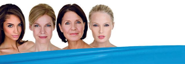 A group of women are standing next to each other in a pool of water.