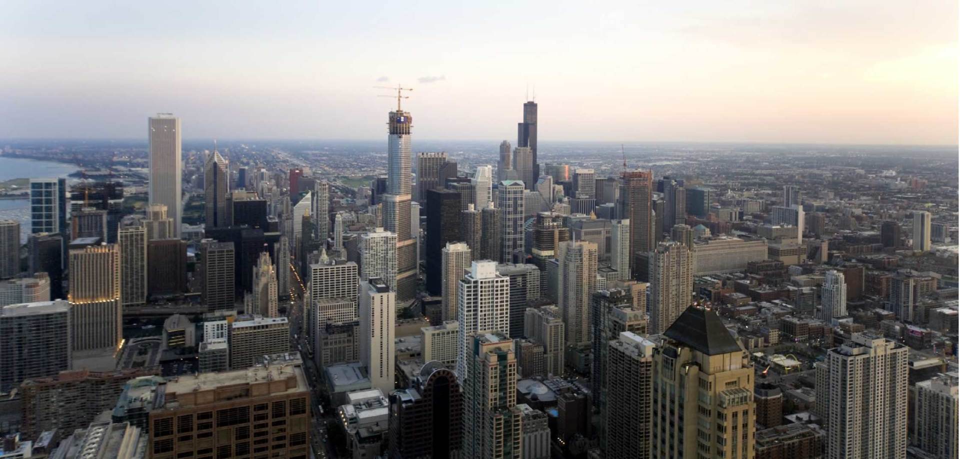 An aerial view of a city skyline at sunset.