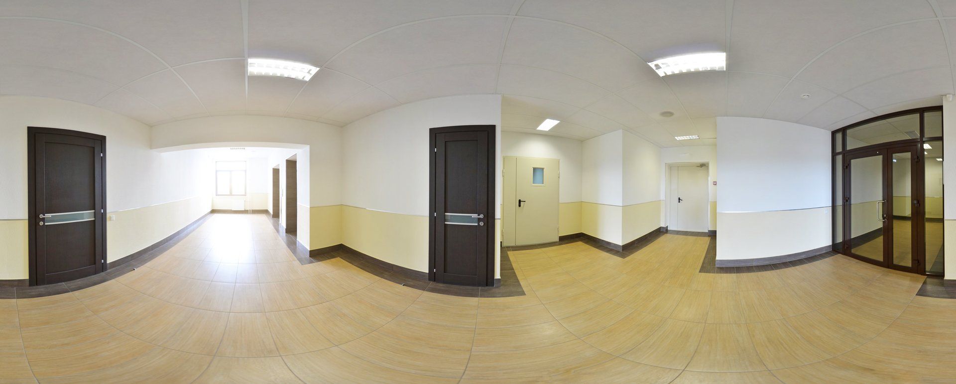 A panoramic view of an empty hallway in a building.