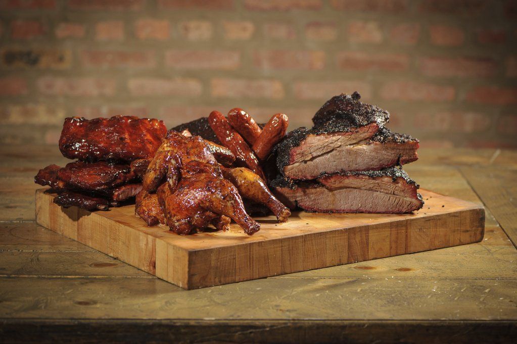 There are many different types of meat on the cutting board.