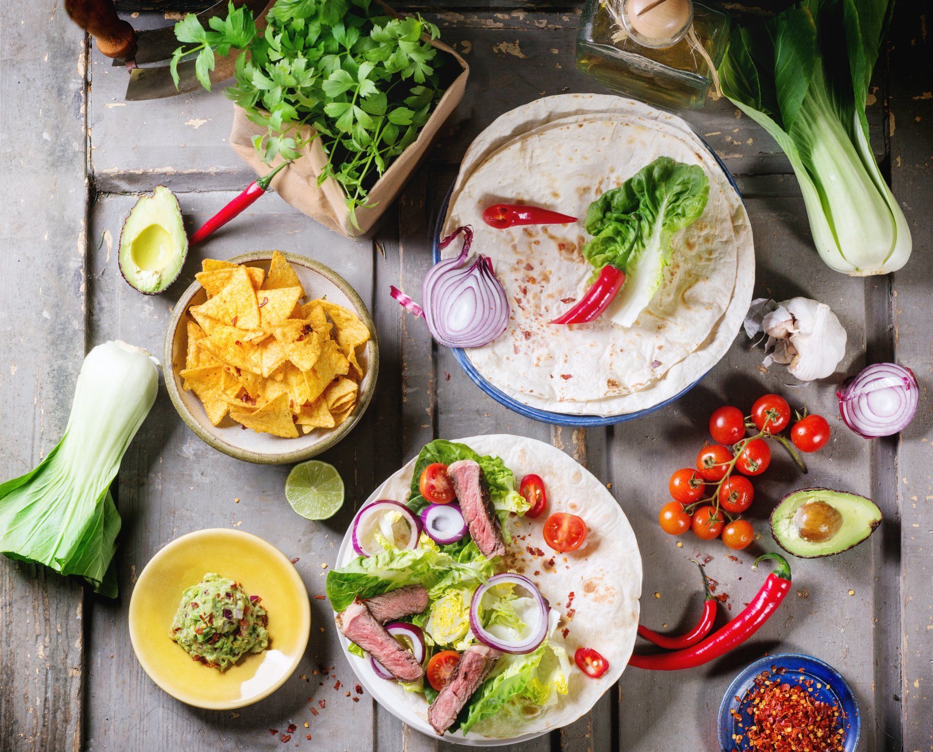 A table topped with plates of food and vegetables.