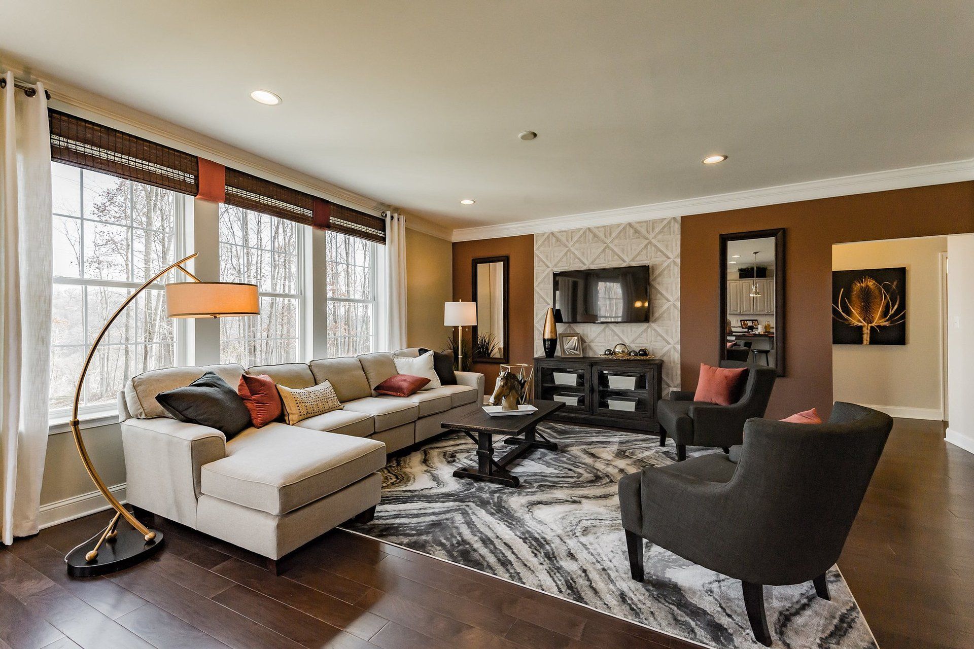 A living room with a couch , chairs , and a lamp.