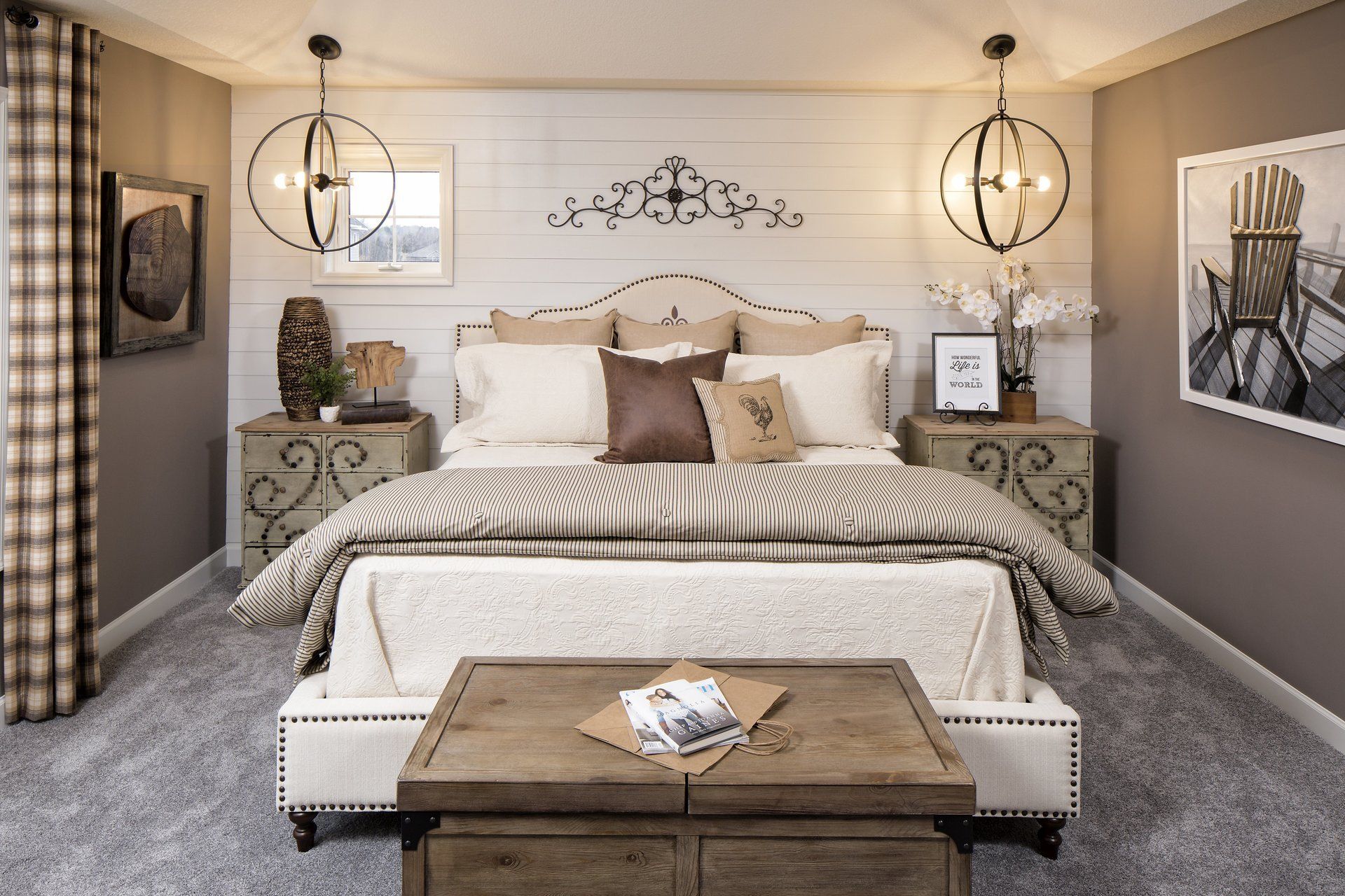 A bedroom with a king size bed , nightstands , and a coffee table.