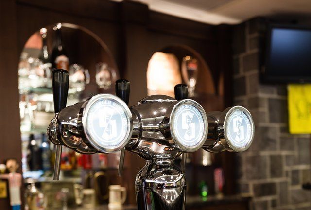 A close up of a beer tap in a bar.