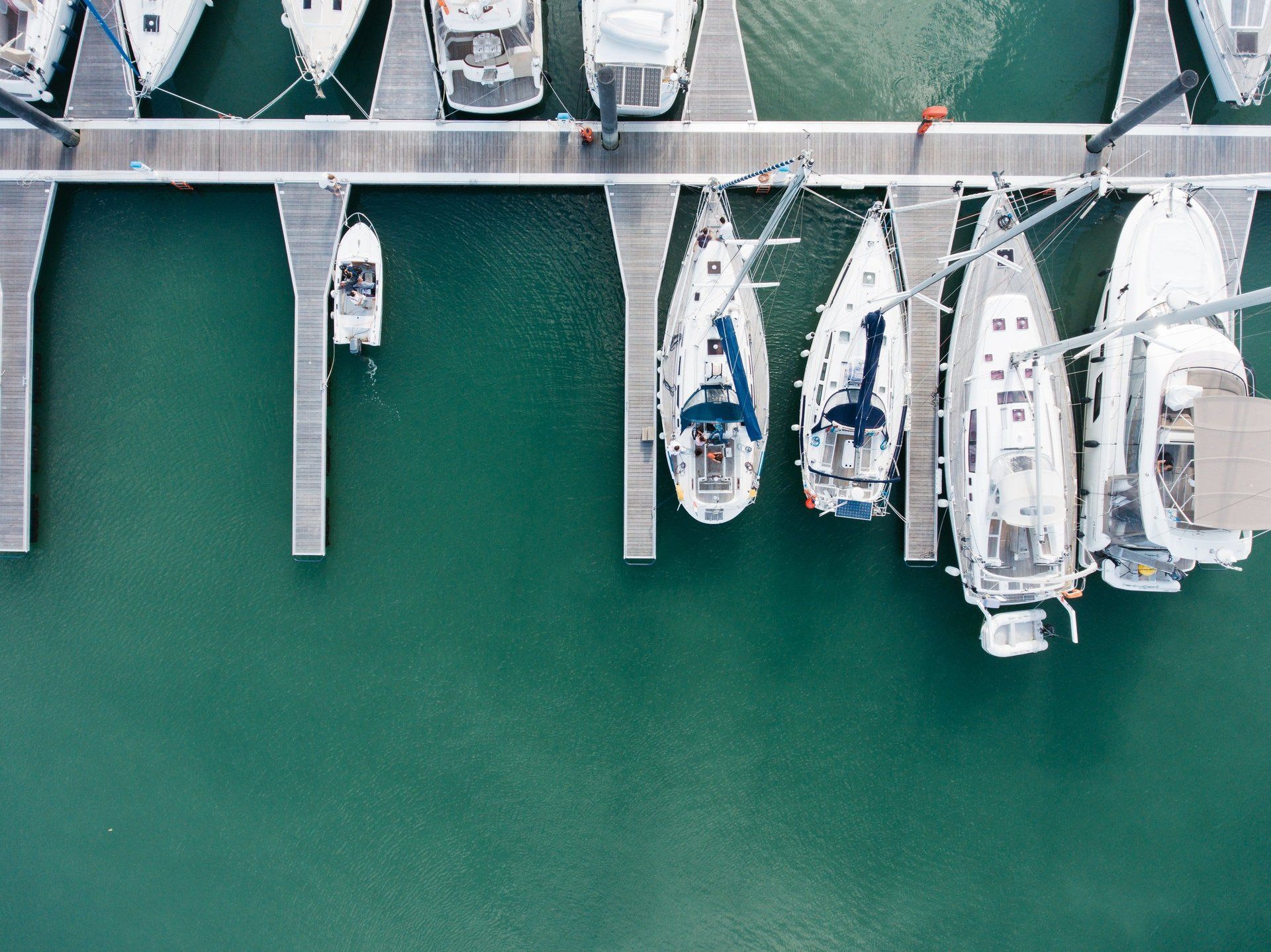 A group of boats are docked at a marina.