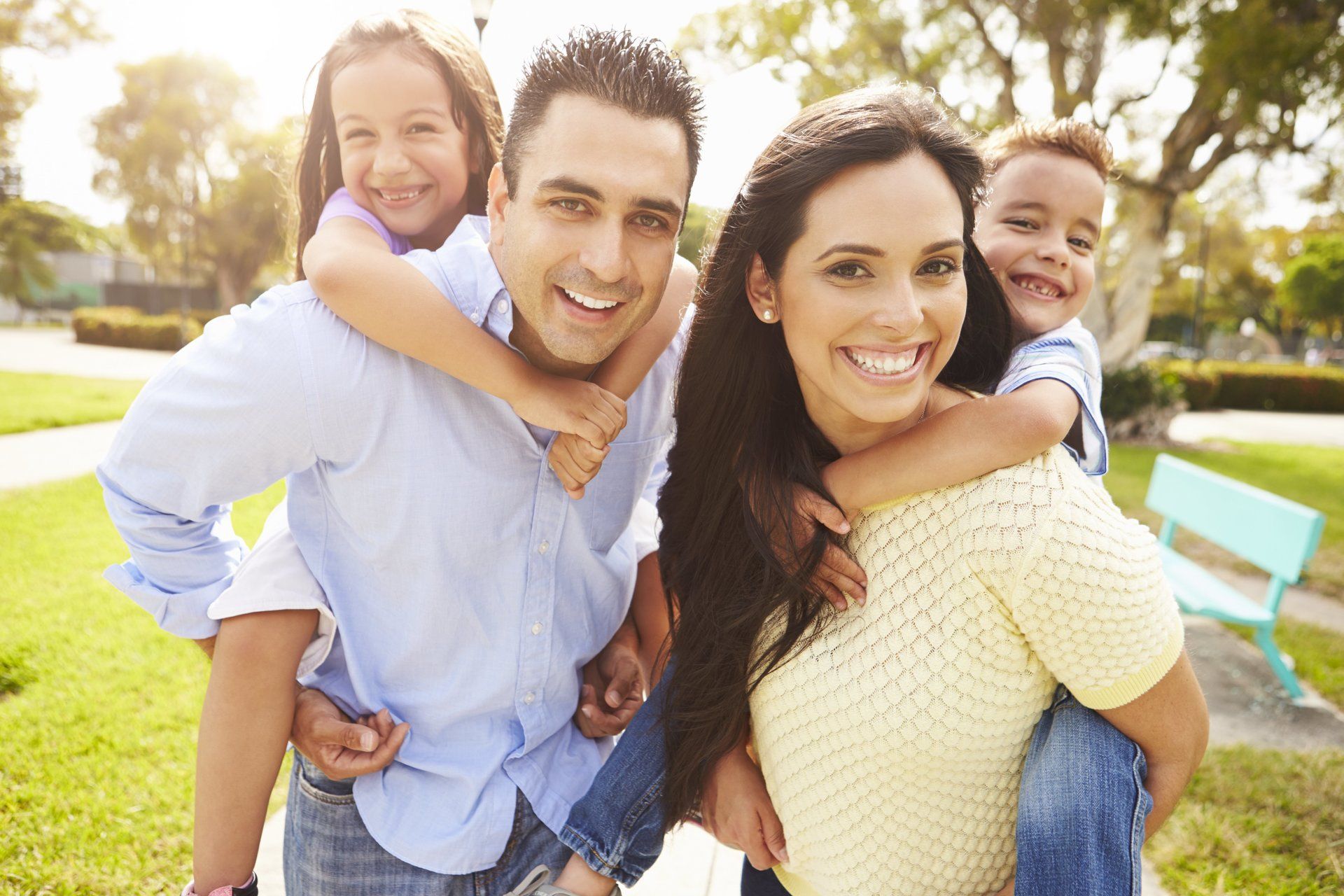 A family is posing for a picture in a park.