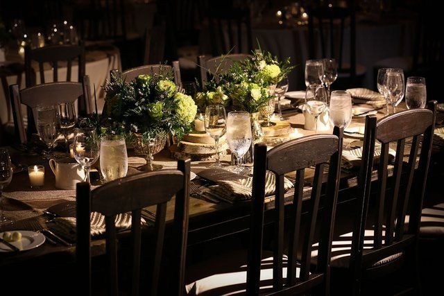A long table with a bunch of flowers on it