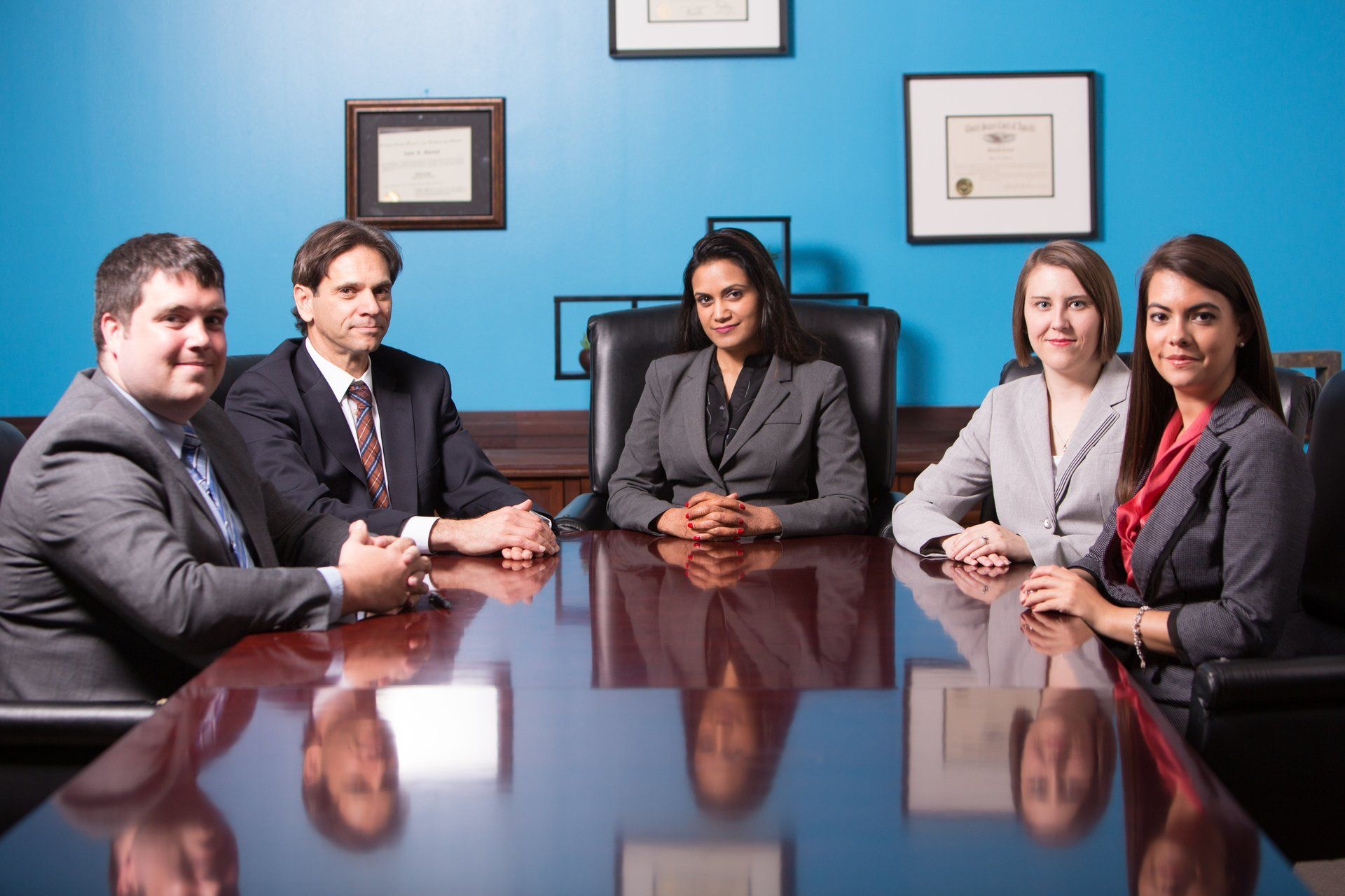 A group of people are sitting around a conference table.