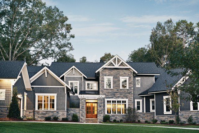 A large house with a lot of windows and a blue roof