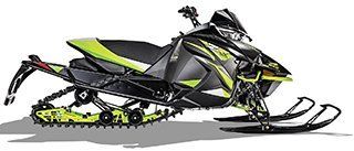 A black and yellow snowmobile is sitting on a white surface.