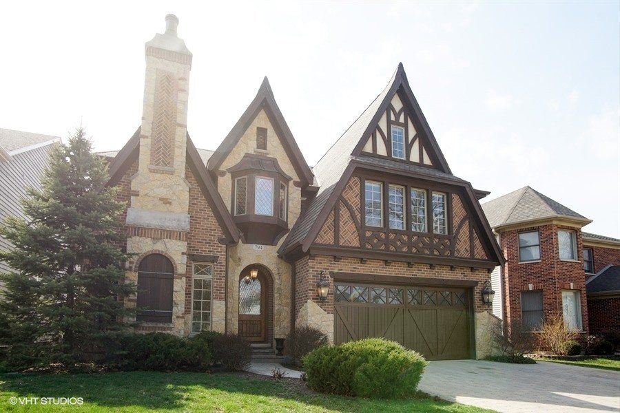 A large brick house with a green garage door