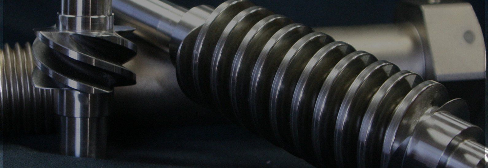 A close up of a gear and a worm gear on a table.