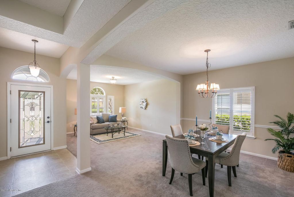 There is a dining room table and chairs in the middle of the room.