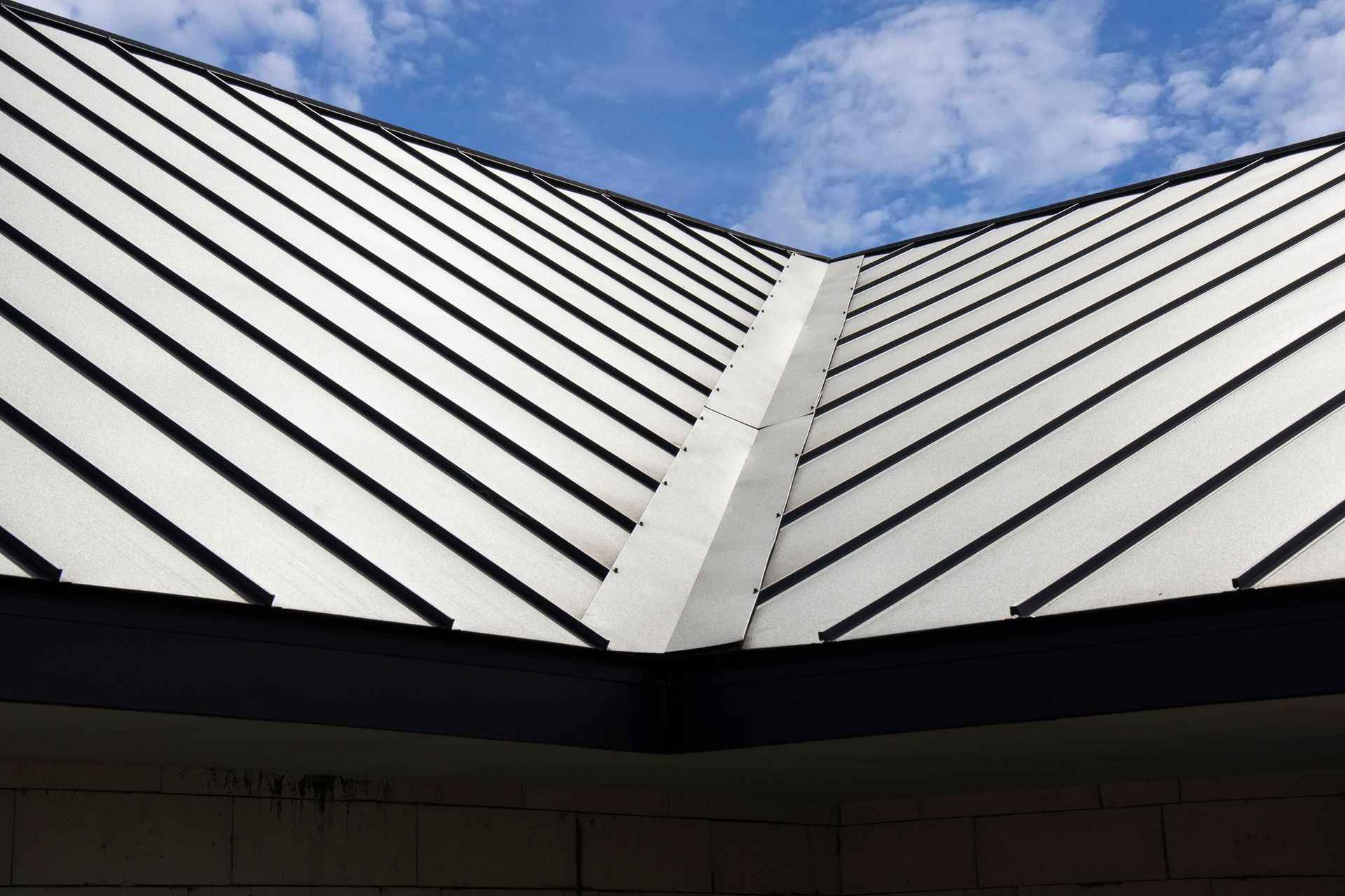 Residential property featuring a newly installed modern roof. Residential property featuring a newly installed modern roof.