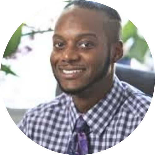 A man in a suit and blue shirt smiles for the camera
