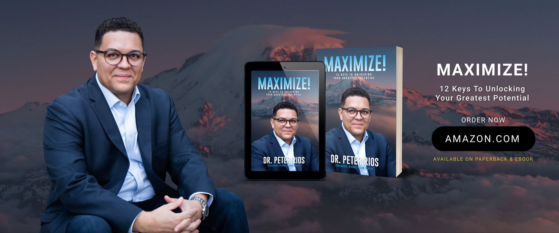 Dr. Peter Rios sitting next to his book