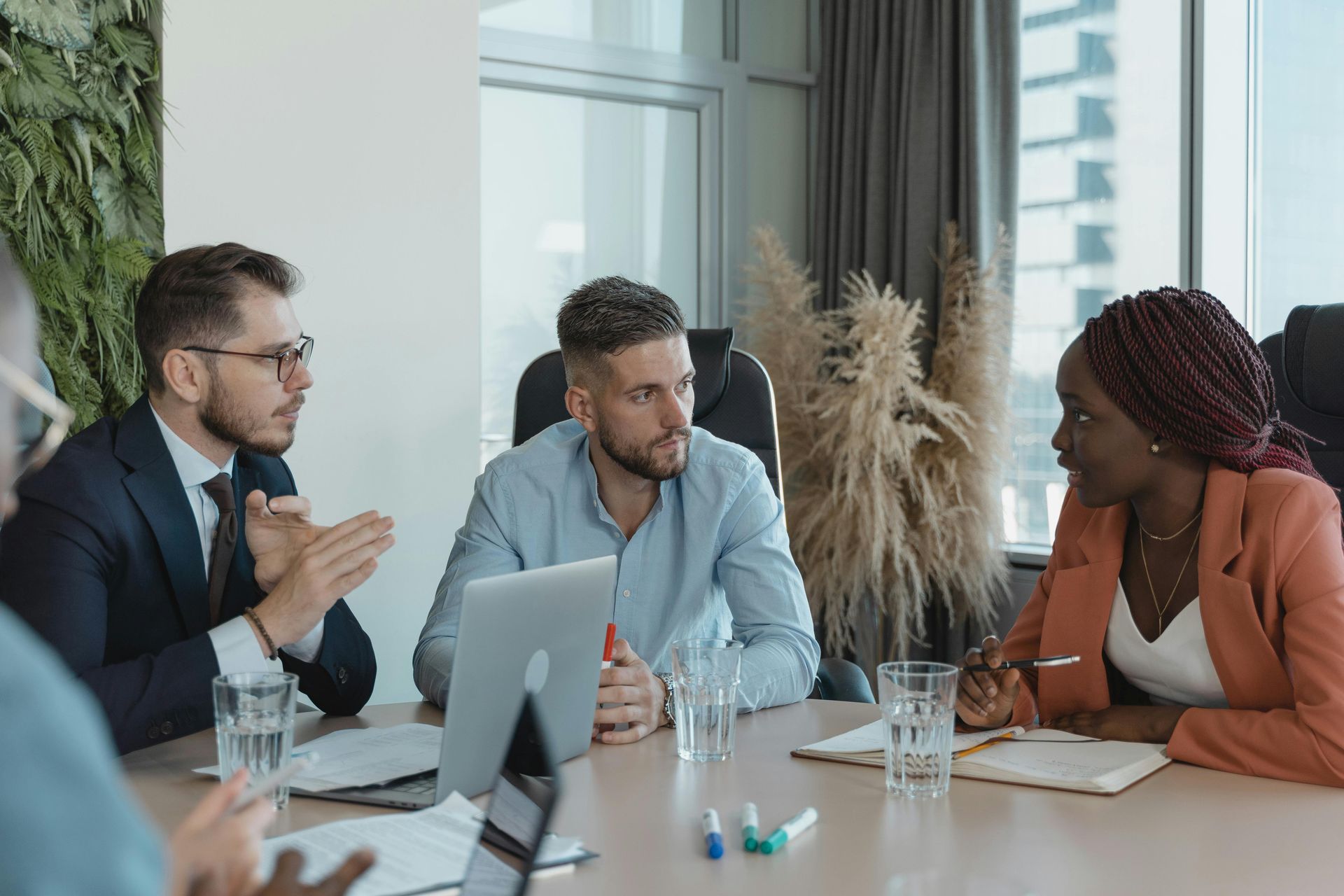 Businesspeople in a meeting at a conference table, discussing ideas.
