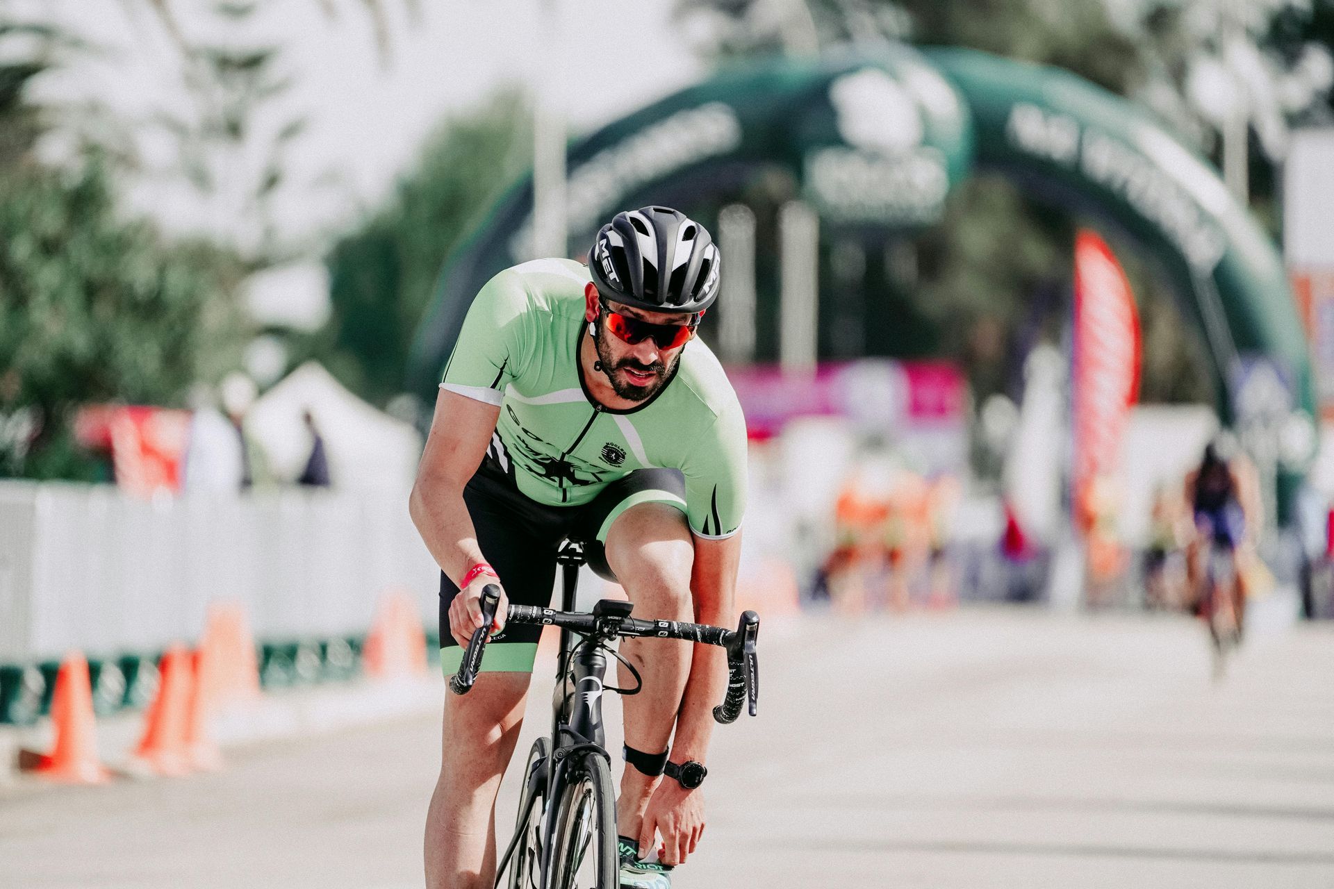 A man is riding a bike on a road.