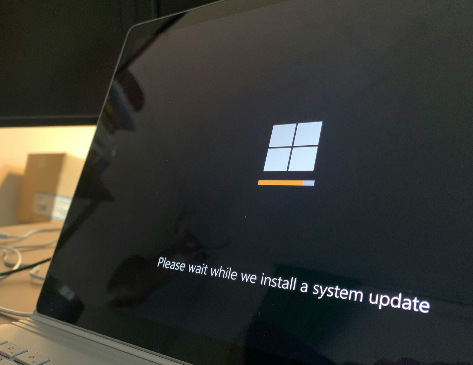 Laptop screen displaying Windows system update in progress.