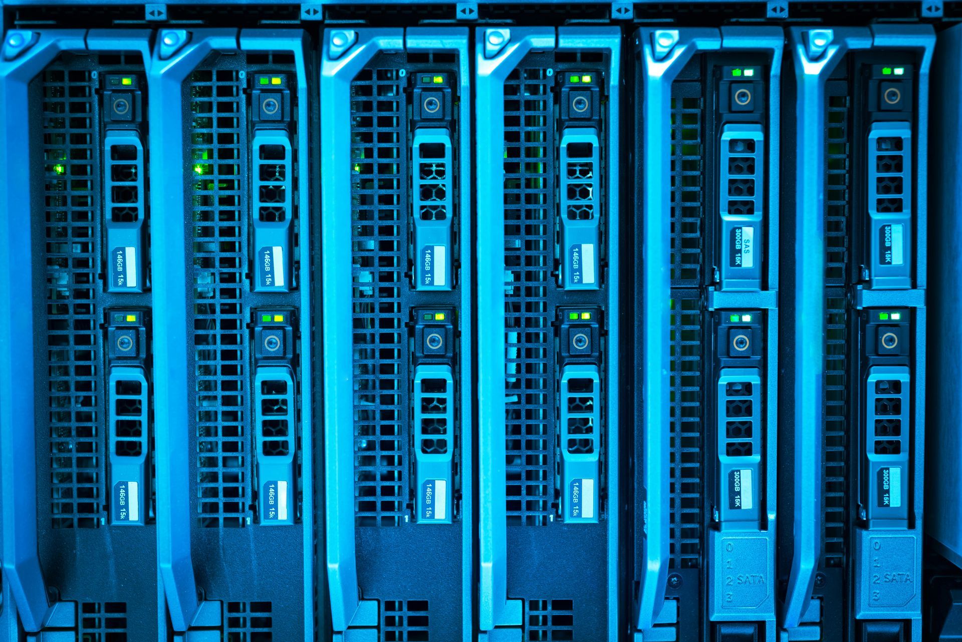 A row of server blades in a rack, glowing with bright blue ambient light and illuminated status indicators.