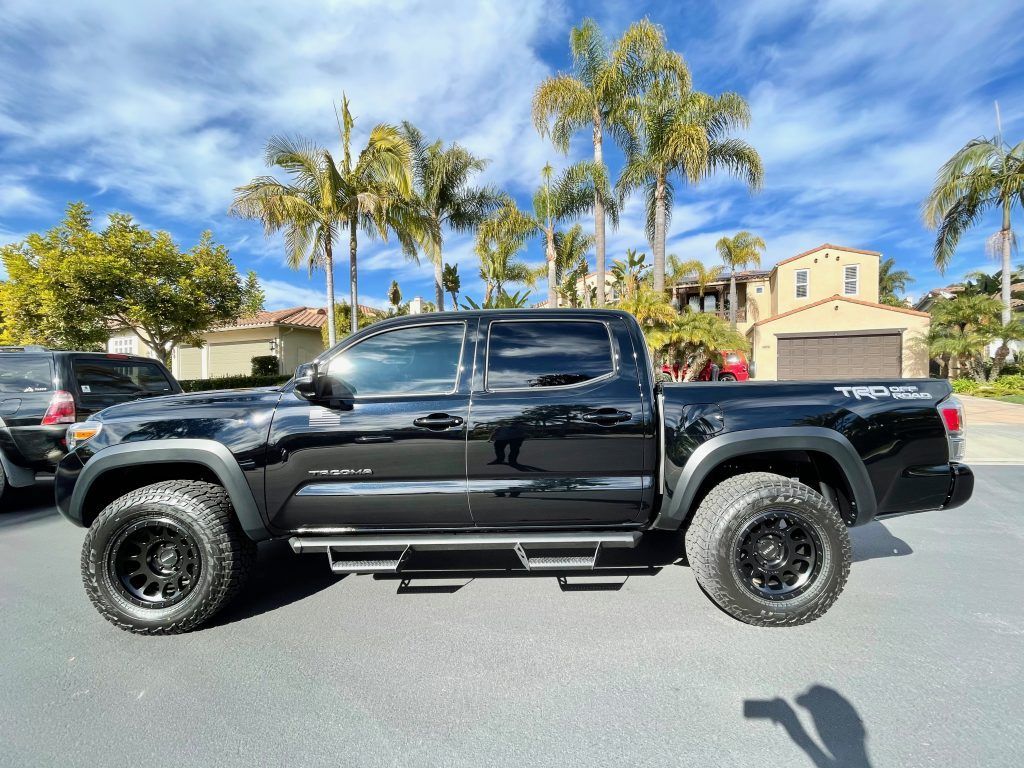 A blue dodge challenger is parked in a parking lot