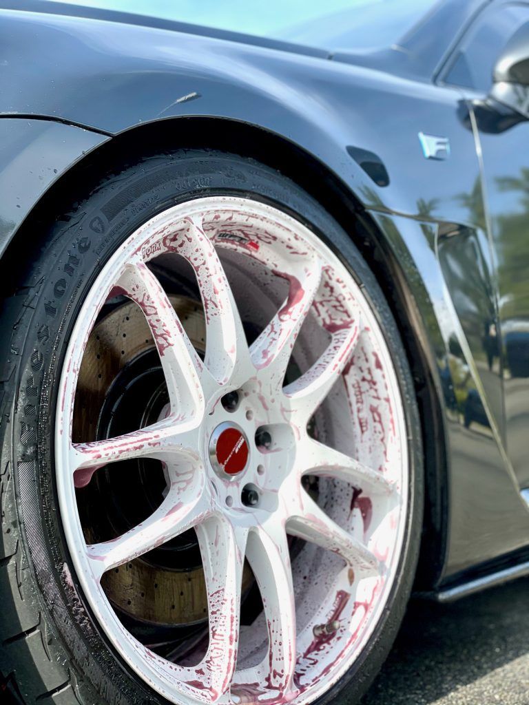 A close up of a car wheel with red paint on it.