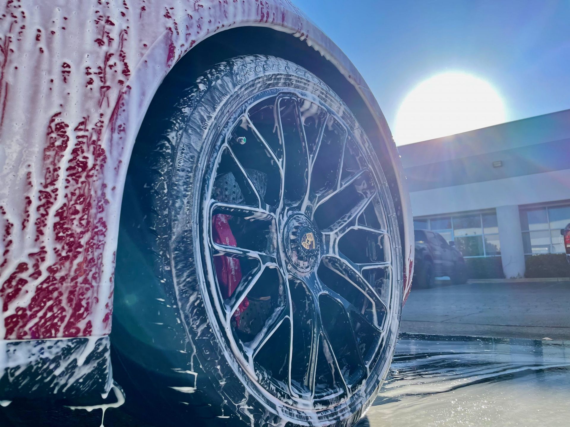 A close up of a car wheel covered in foam.