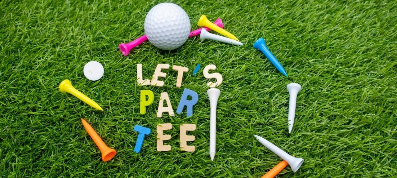 Golf ball, tees, and clubs around 