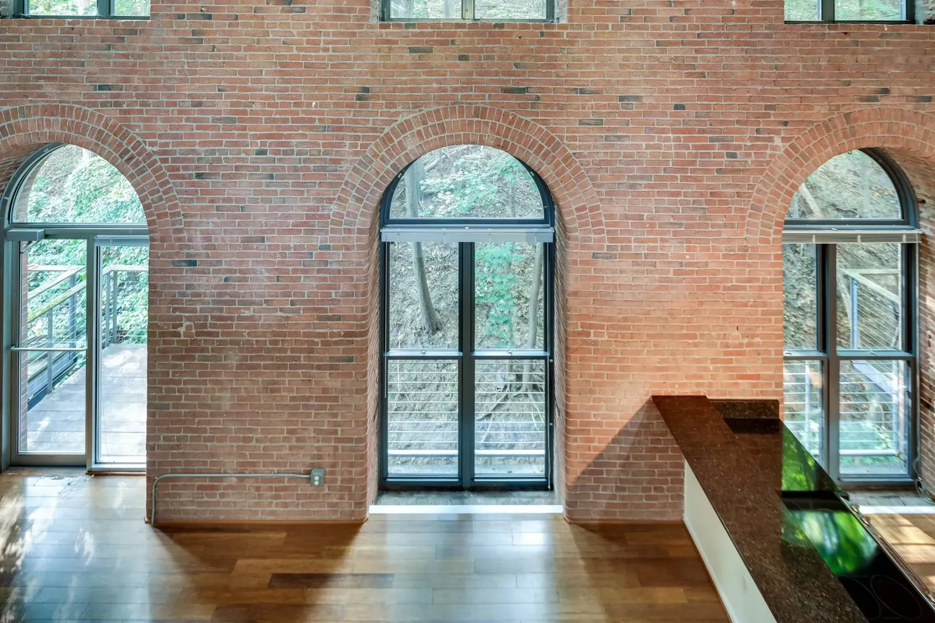 a large room with arched windows and a brick wall .
