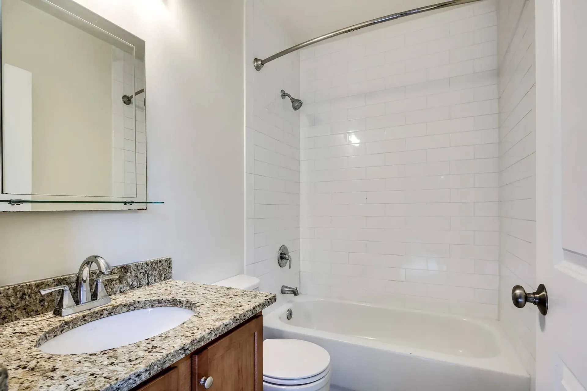 bathroom with vanity, toilet and shower/bath combo