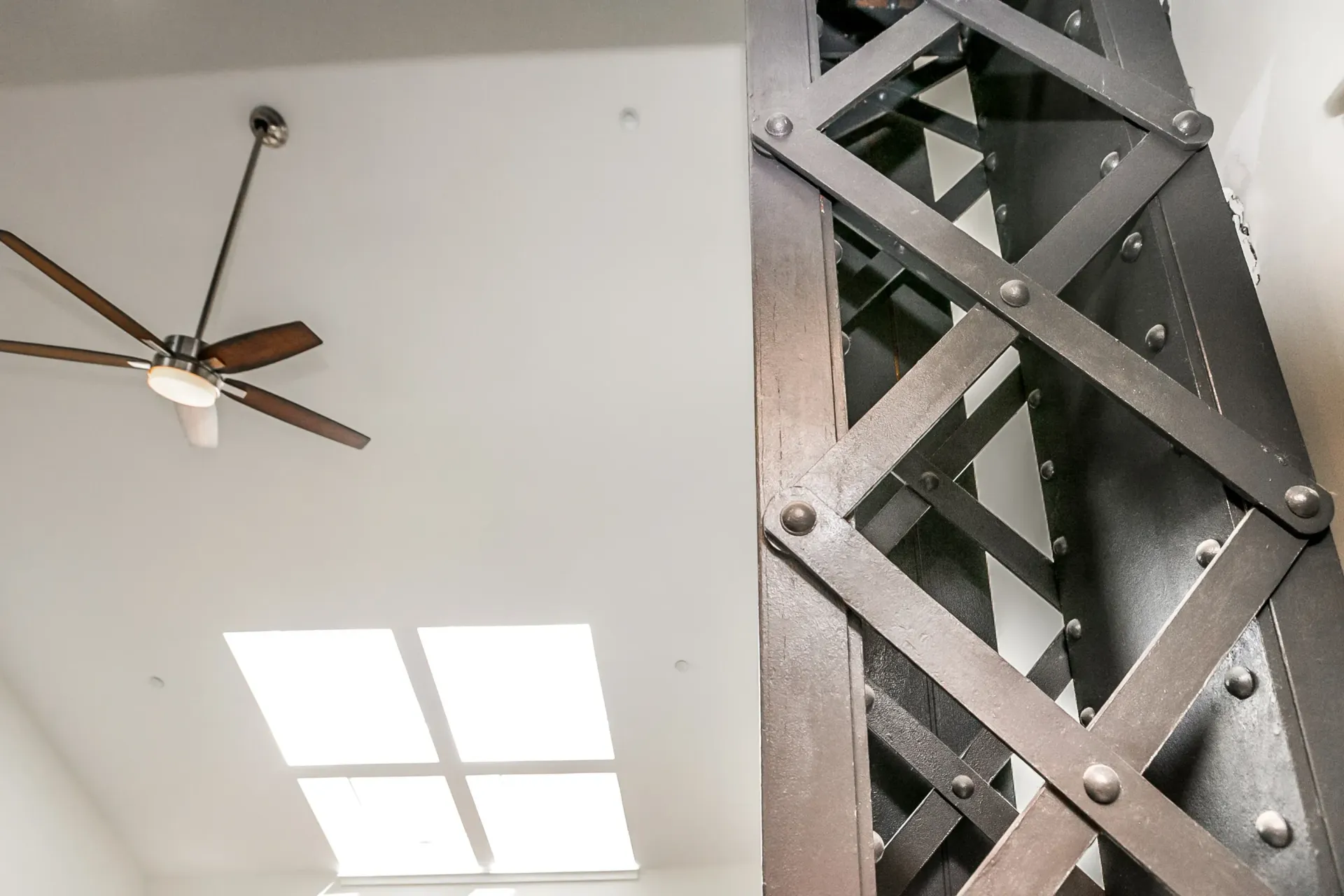 a ceiling fan is hanging from the ceiling of a room .