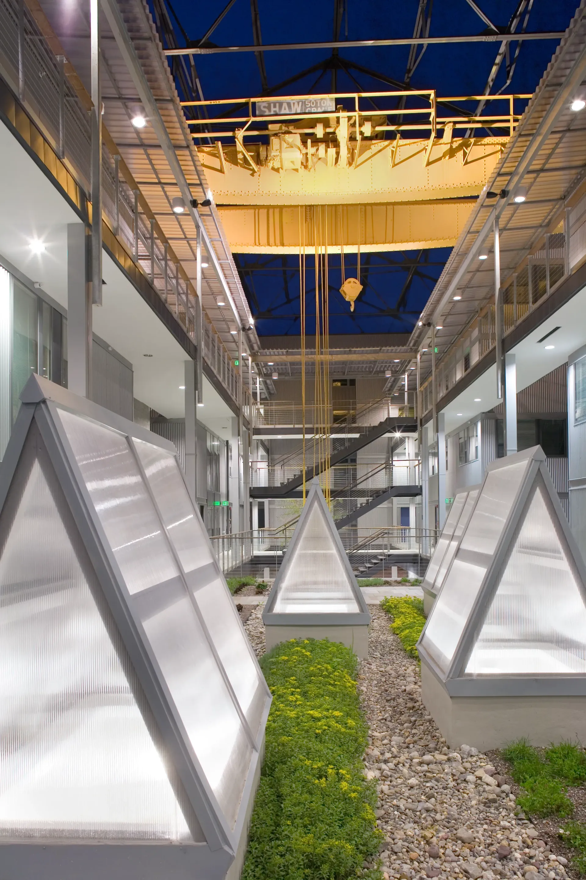 a large building with a lot of windows and a crane hanging from the ceiling .