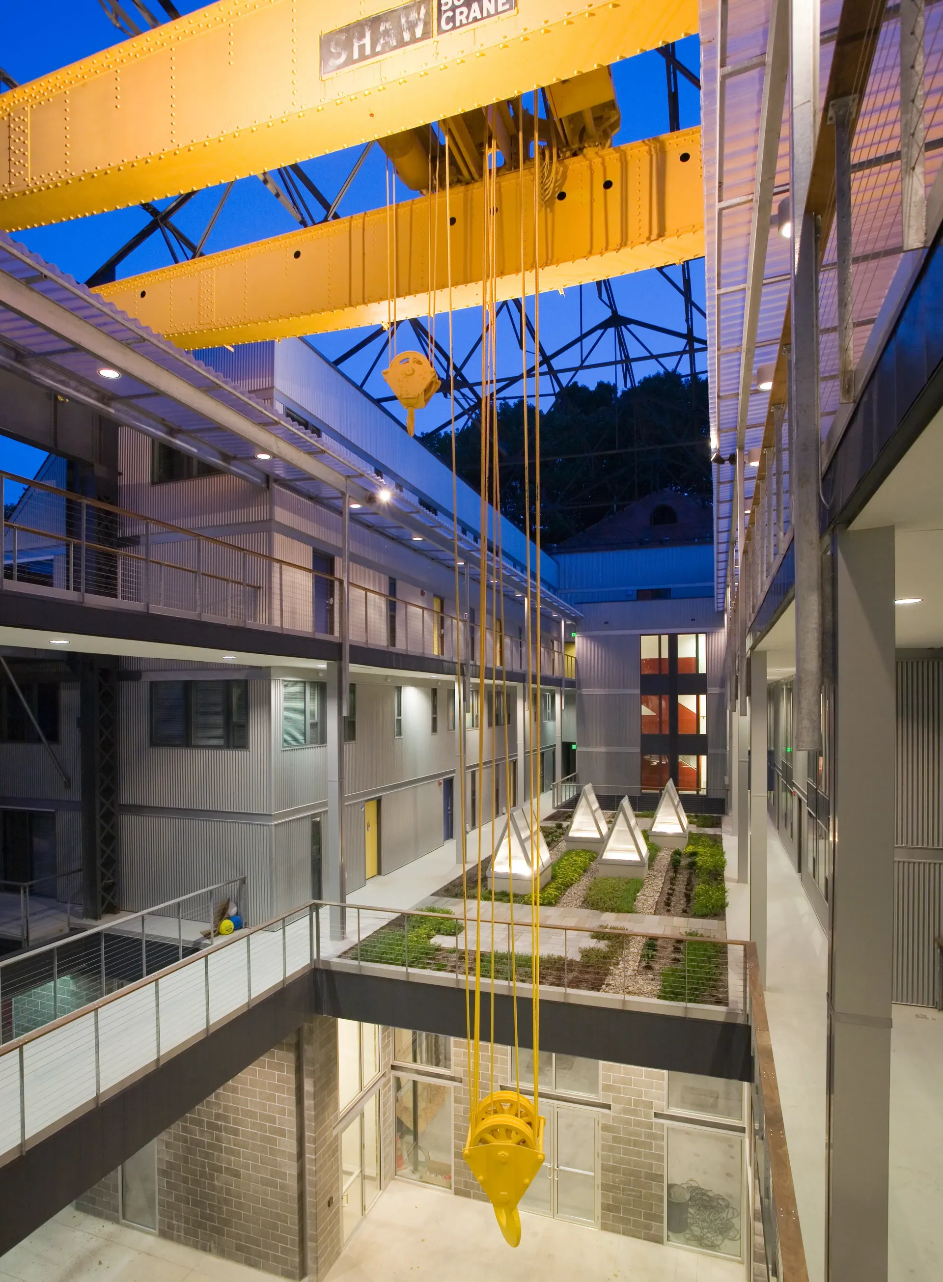 a large yellow crane is hanging from the ceiling of a building .