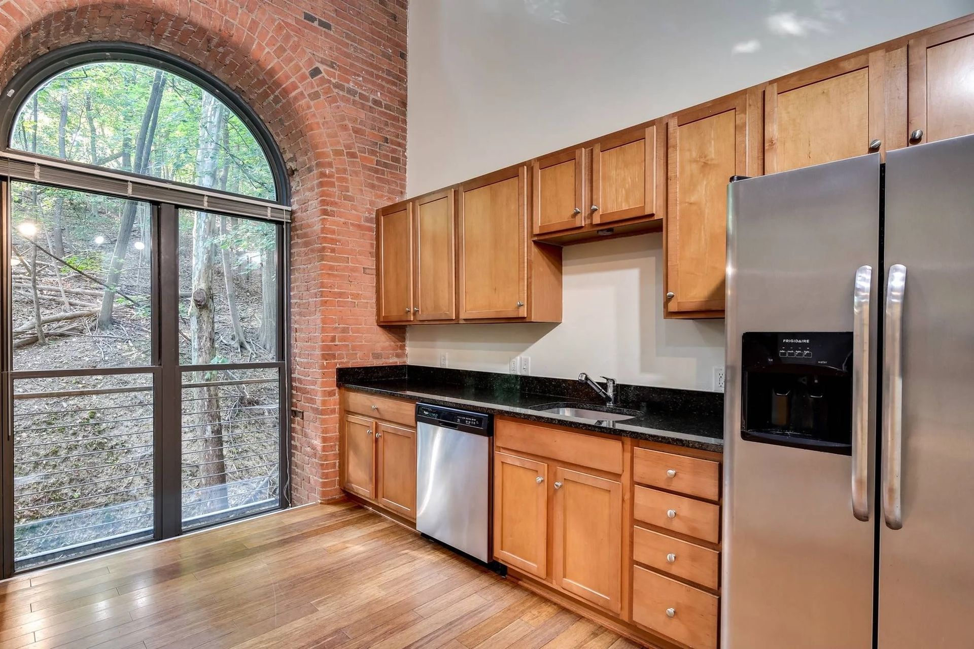 a kitchen with stainless steel appliances and wooden cabinets