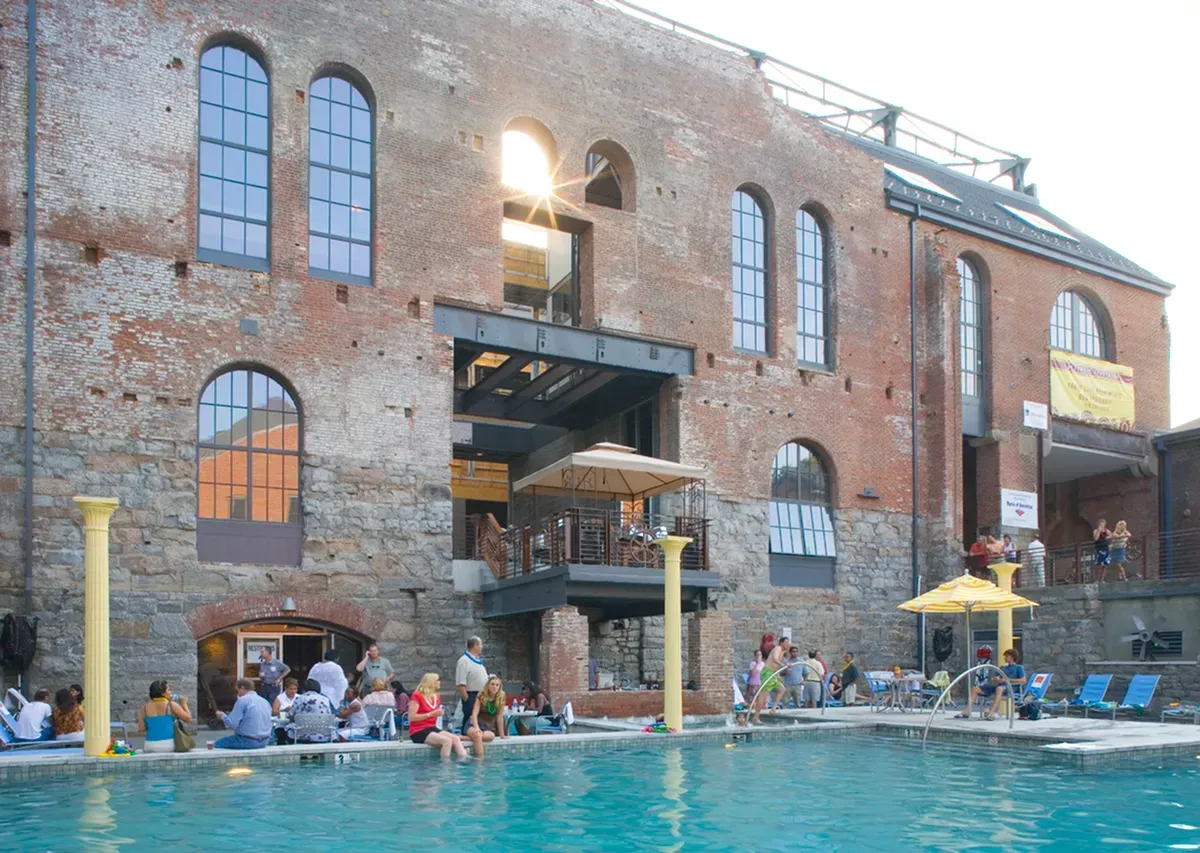 a large brick building with a swimming pool in front of it
