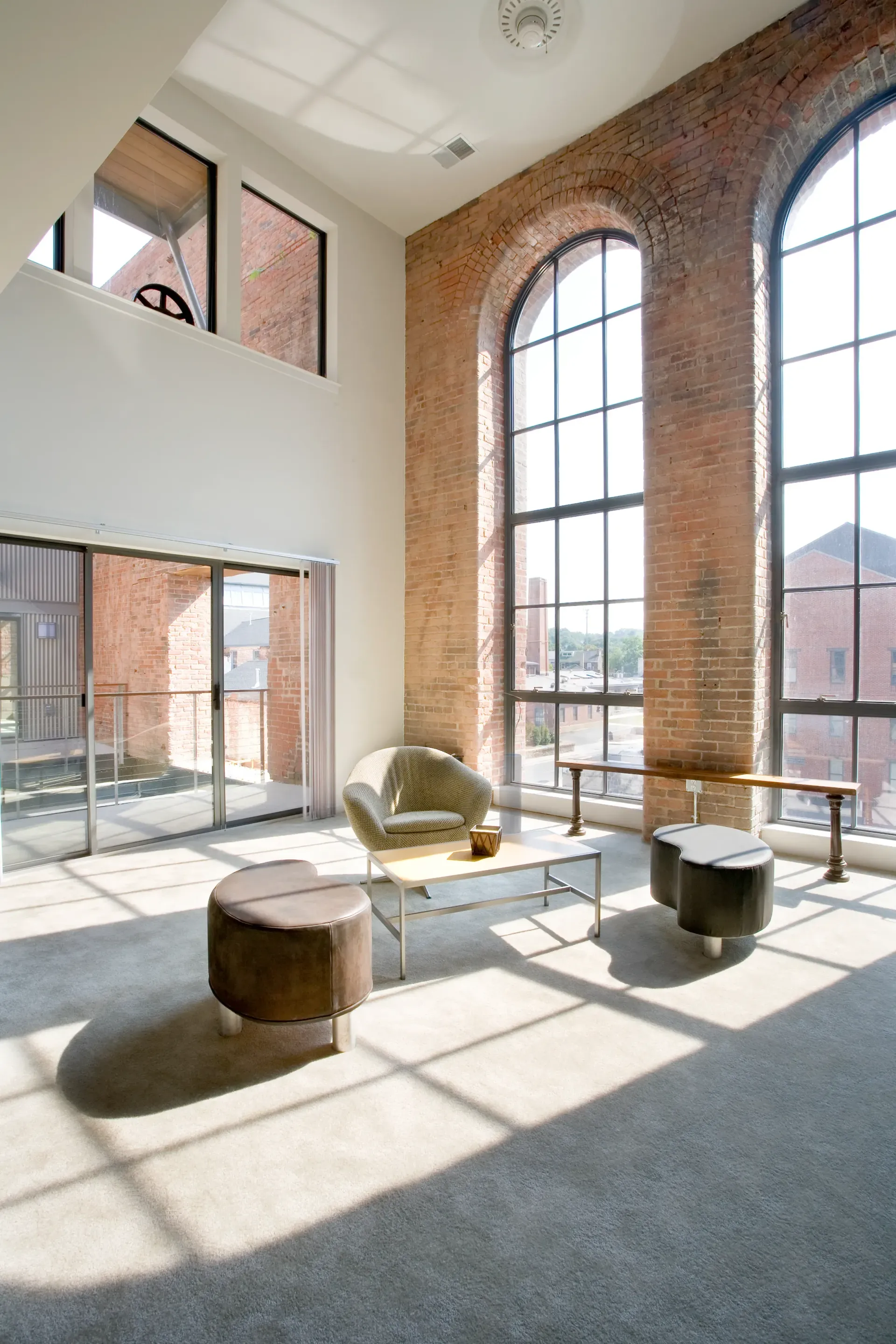 a living room with a lot of windows and furniture